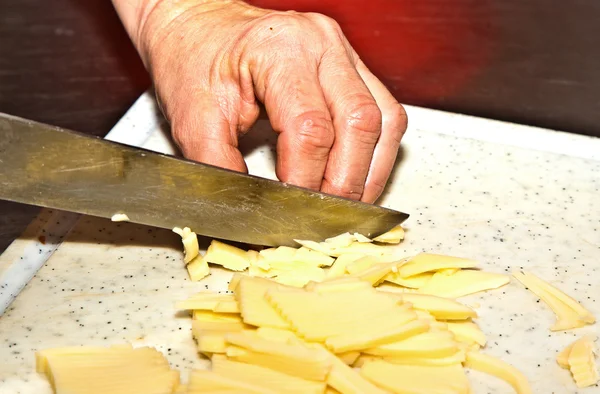 Cutting food with knife in the kitchen — Stock Photo, Image