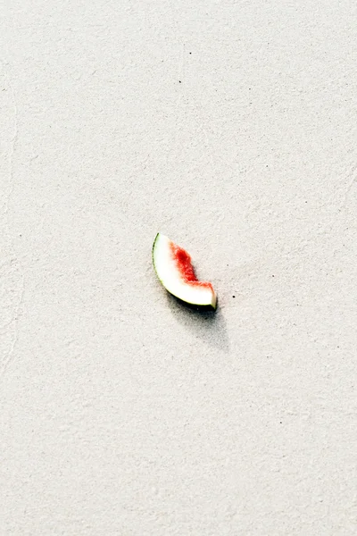 Melon lies at the fine sandy beach — Stock Photo, Image