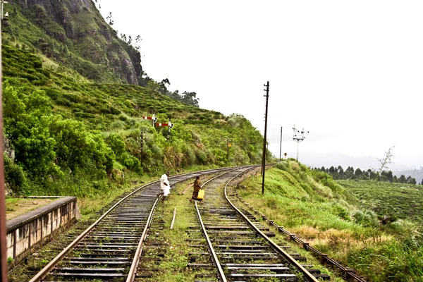 Walking on the rails of the railway in the highlands — 图库照片