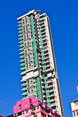 Facade of houses downtown Kowloon with appartments and air condi clipart