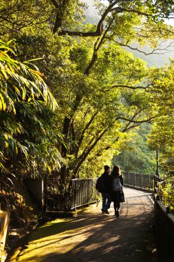 Couple walks the romantic peak way in Hong Kong, Victoria clipart