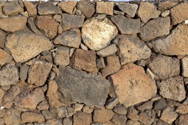 Typical wall made seamless from volcanic stone clipart