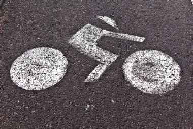 Signs for bicycle lane are painted on the street clipart