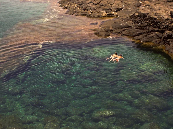 Diving in a natural basin in the rocks coastline of Lanza — Stock Photo, Image