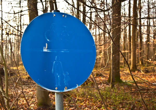 Pedestrian sign with nearly lost color in the forest — Stock Photo, Image