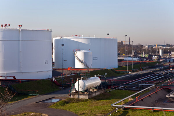 White tanks in tank farm with blue sky
