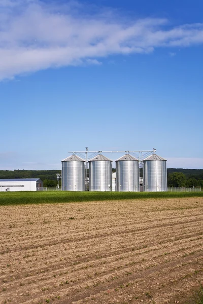 Silver shining silo with acre in landscape — Stock Photo, Image