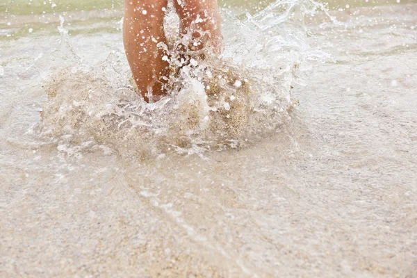 Pés de menino pulando na água — Fotografia de Stock
