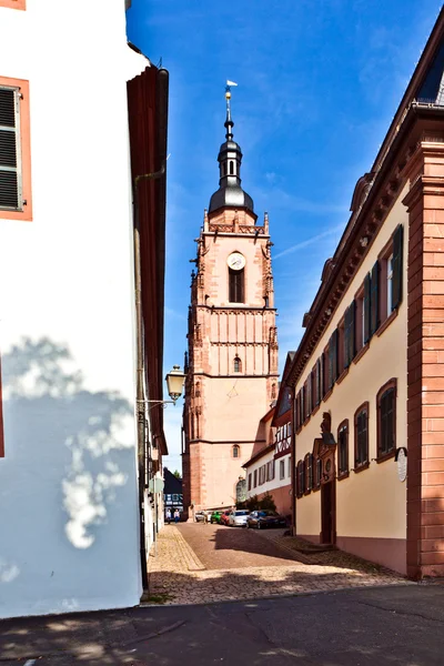 Medieval street with church tower — Stock Photo, Image