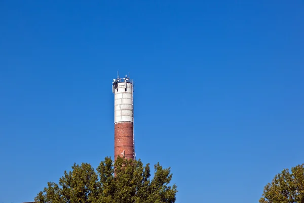 Chimney of old abandoned industrial building — Stock Photo, Image