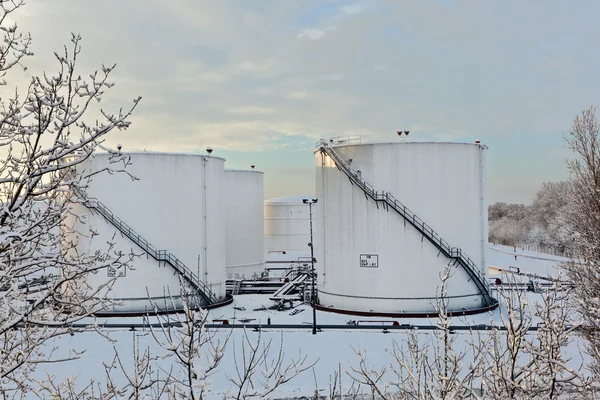 stock image White tanks in tank farm with snow in winter