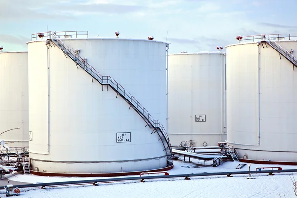 stock image White tanks in tank farm with snow in winter