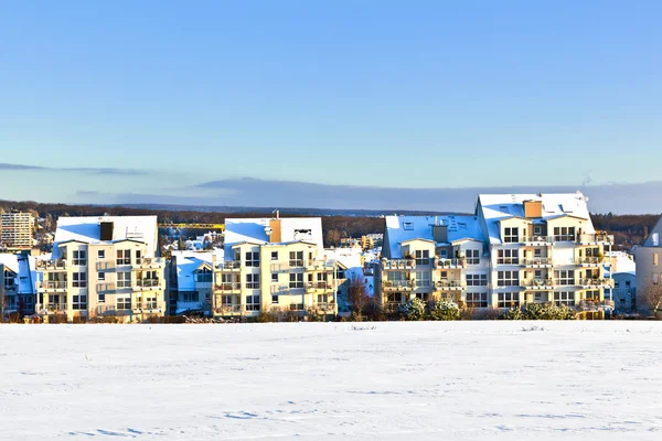 stock image Beautiful landscape with housing area in winter and blue sky