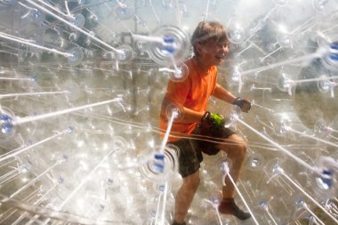 Child has a lot of fun in the Zorbing Ball clipart