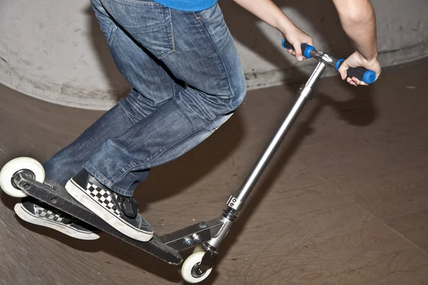 Jumping with scooter in skate hall — Stock Photo, Image