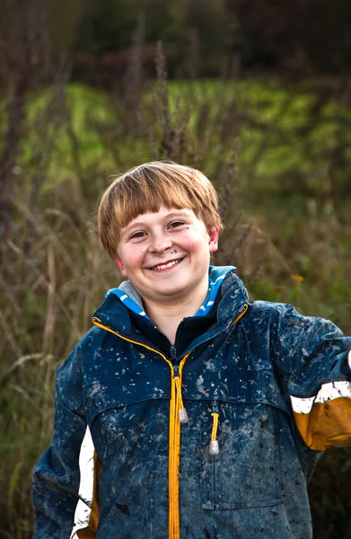 Boy after a quad trip with dirt on face — Stock Photo, Image