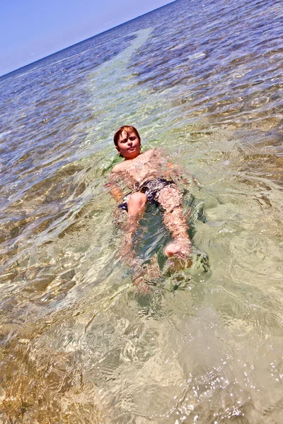 Fiú a hátán úszik — Stock Fotó