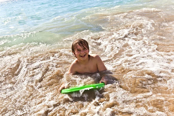 Хлопчик розважається з дошкою для серфінгу — стокове фото