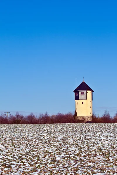 Water tower in beautiful landscape with blue sky — Stock Photo, Image