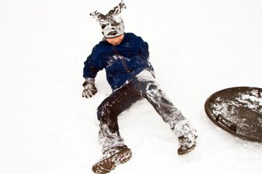 Child sledding down the hill in snow, white winter clipart
