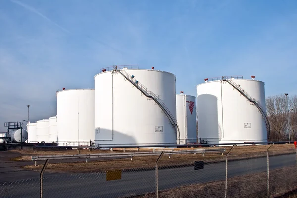 stock image White tanks in tank farm with blue sky