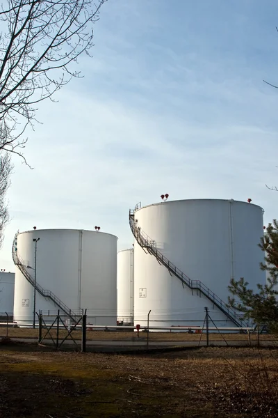 stock image White tanks in tank farm with blue sky