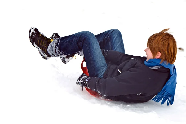 Child sledding down the hill in snow, white winter — Stock Photo, Image