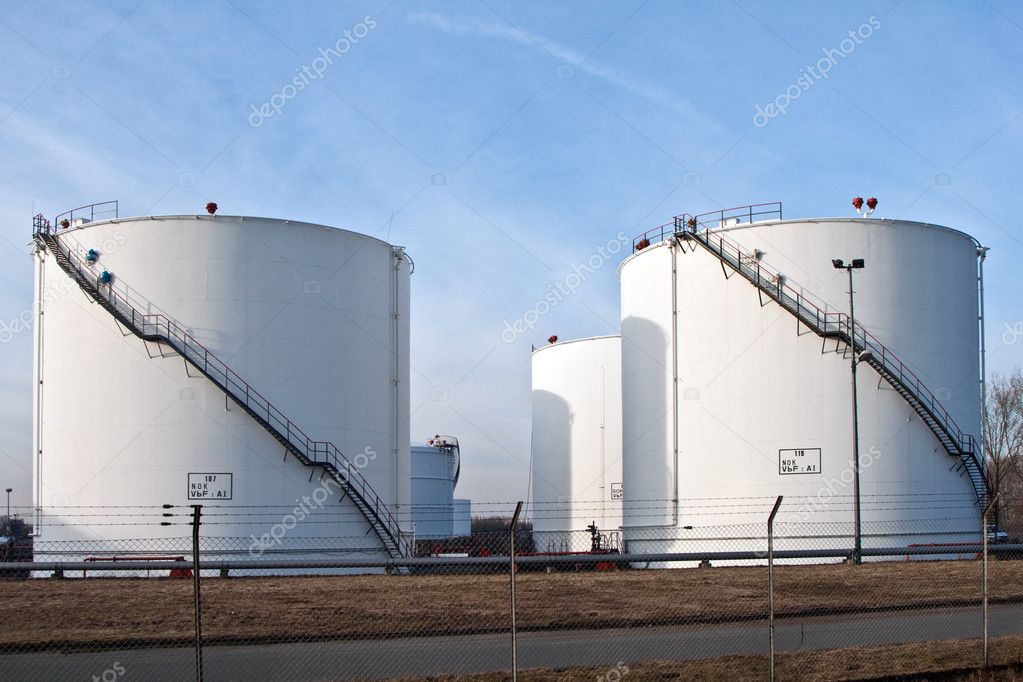 White tanks in tank farm with blue sky — Stock Photo © Hackman #5640558