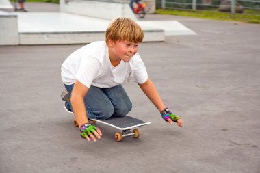 Cute boy scooting with his scooter clipart