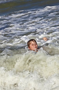 Child has fun in the waves