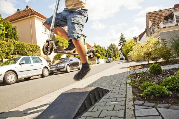 boy riding a scooter going airborne — 图库照片 #5656290