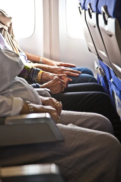 Hands of passengers in the cabin — Stock Photo, Image