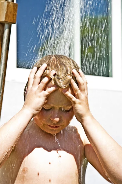 Criança tem um chuveiro refrescante — Fotografia de Stock