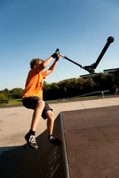 男孩骑踏板车在滑板公园 — 图库照片