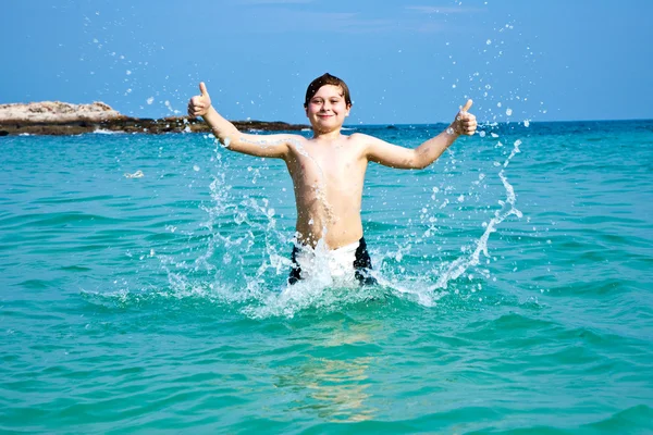 Sonriente chico disfruta nadando en el mar —  Fotos de Stock