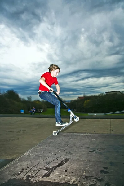 Pojke som flyger med skoter — Stockfoto