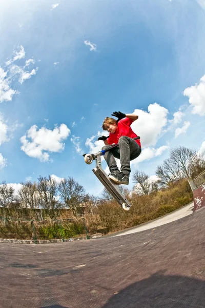 スクーターで空を飛ぶ少年 — ストック写真