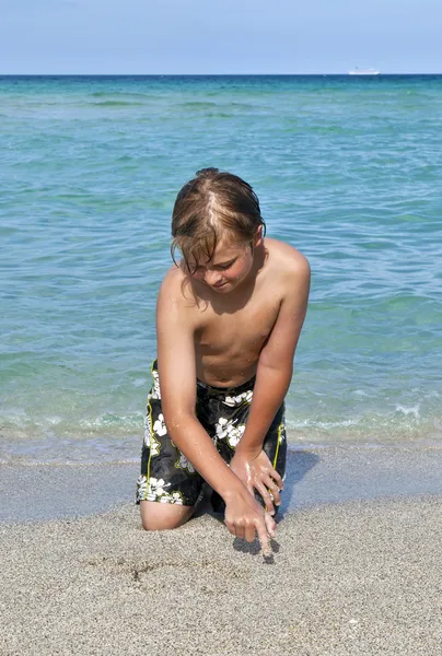 Boy enjoys the clear water in the ocean — Stock Photo, Image