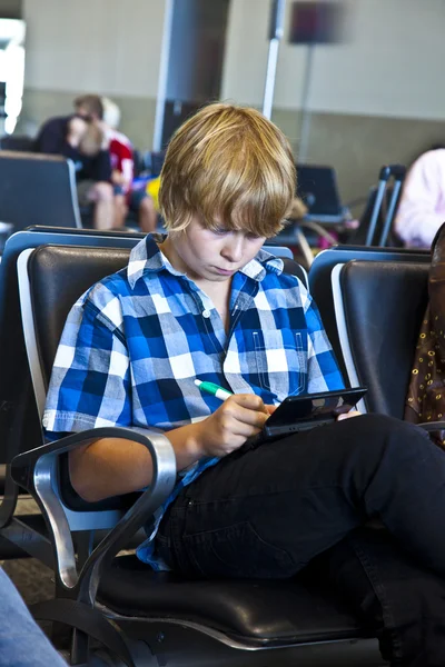Boy is waiting for departure at the airport — Stock Photo, Image