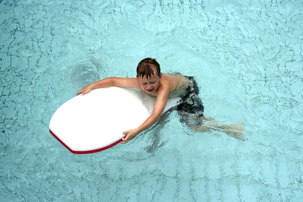 Niño en tabla de surf en la piscina — Foto de Stock