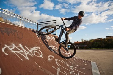 Young boy with dirtbike in halfpipe clipart