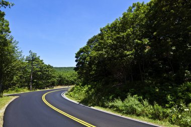 Beautiful scenic country road curves through Shenandoah Nationa clipart