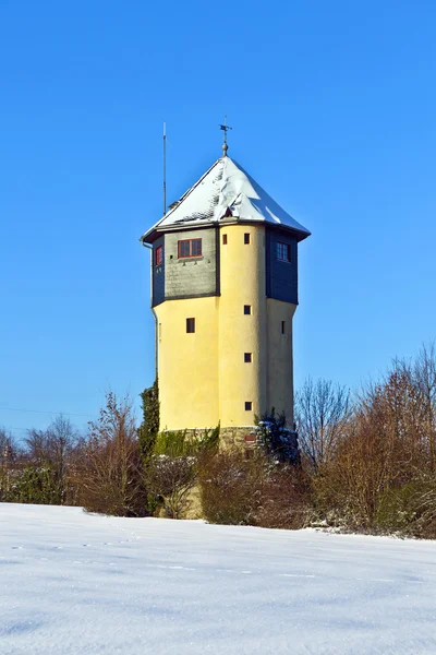 Watertower in snow covered fields — Stock Photo, Image