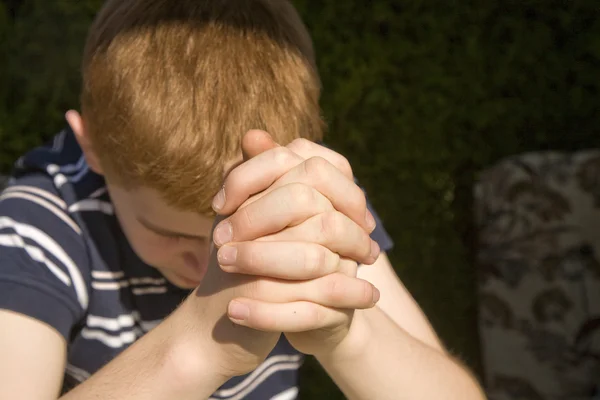 Young red haired boy has his hands folded — Stock Photo, Image