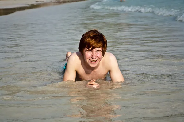 Niño feliz con el pelo rojo está disfrutando de la hermosa playa — Foto de Stock