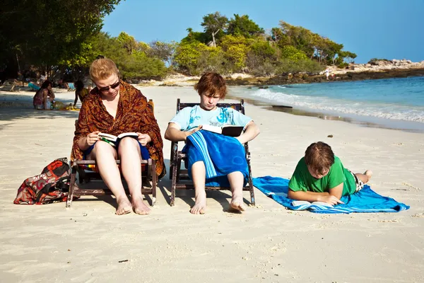 stock image Family is enjoying the sun, relaxing, sitting at the beach and r