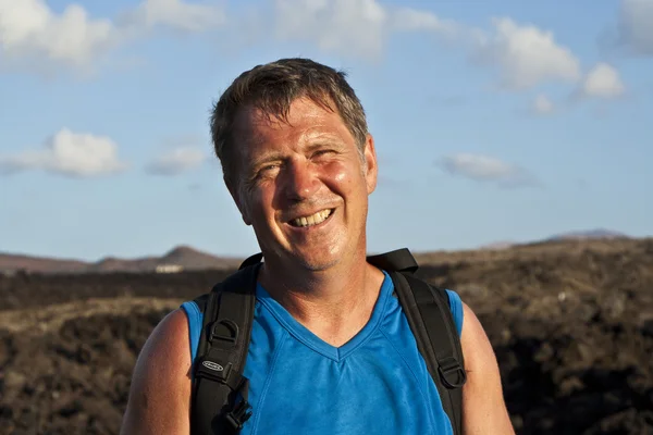 stock image Man on walking trail on volcanic area in Lanzarote