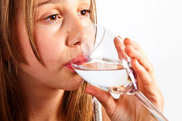 Portrait of cute young teenage girl drinking out of a glass — Stock Photo, Image