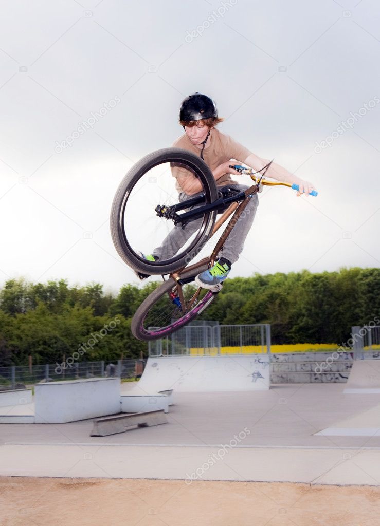 Young boy going airborne with bike