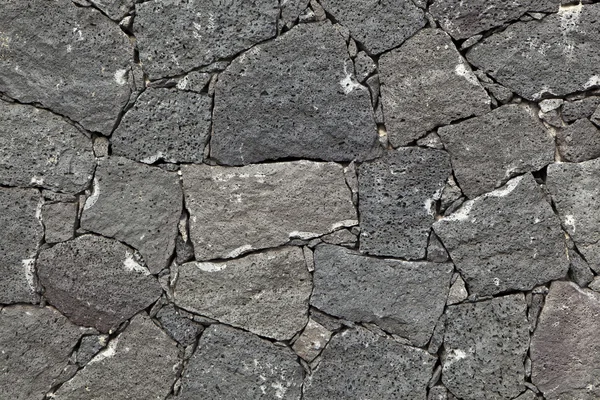 Typische muur gemaakt naadloze van vulkanische steen — Stockfoto